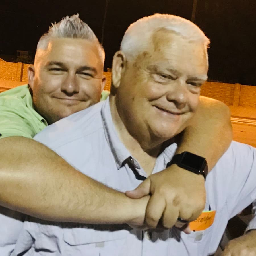 Ryan with his arm around his dad, Les, both smiling